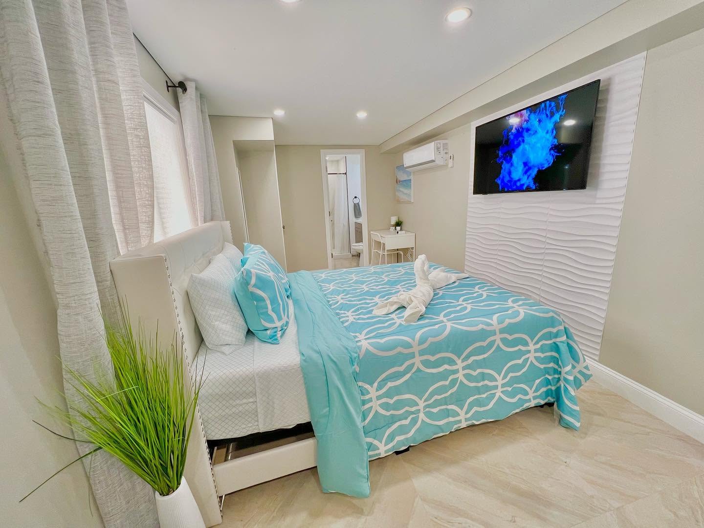 Bedroom with a white wave-textured 3D accent panel wall.