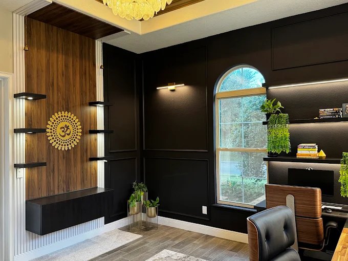 Study with a dark wood slat feature wall, floating black shelves and built-in desk cabinetry.